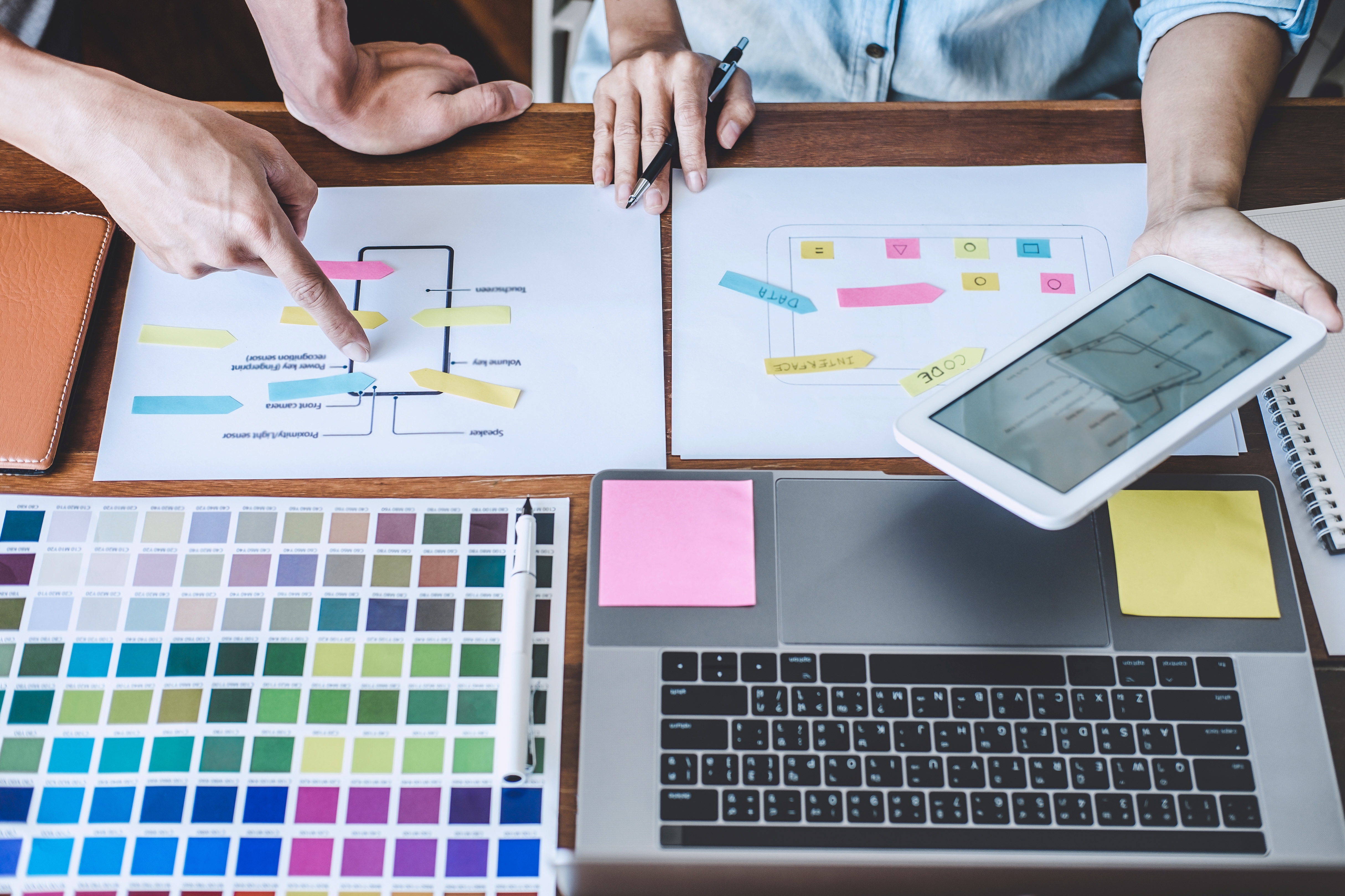 An array of creative materials and colours lie on a table